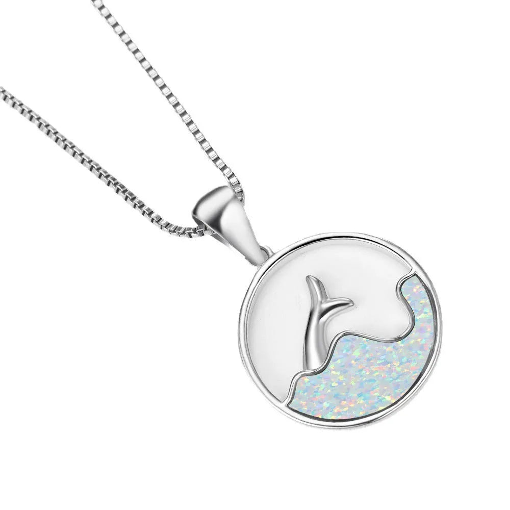 White gold electroplated necklace with a round geometric fishtail pendant in blue opal colour.