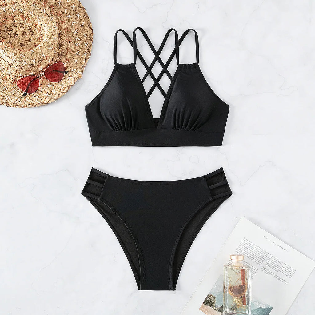 Women's black V-neck halter bikini with split-style shorts on a mannequin.