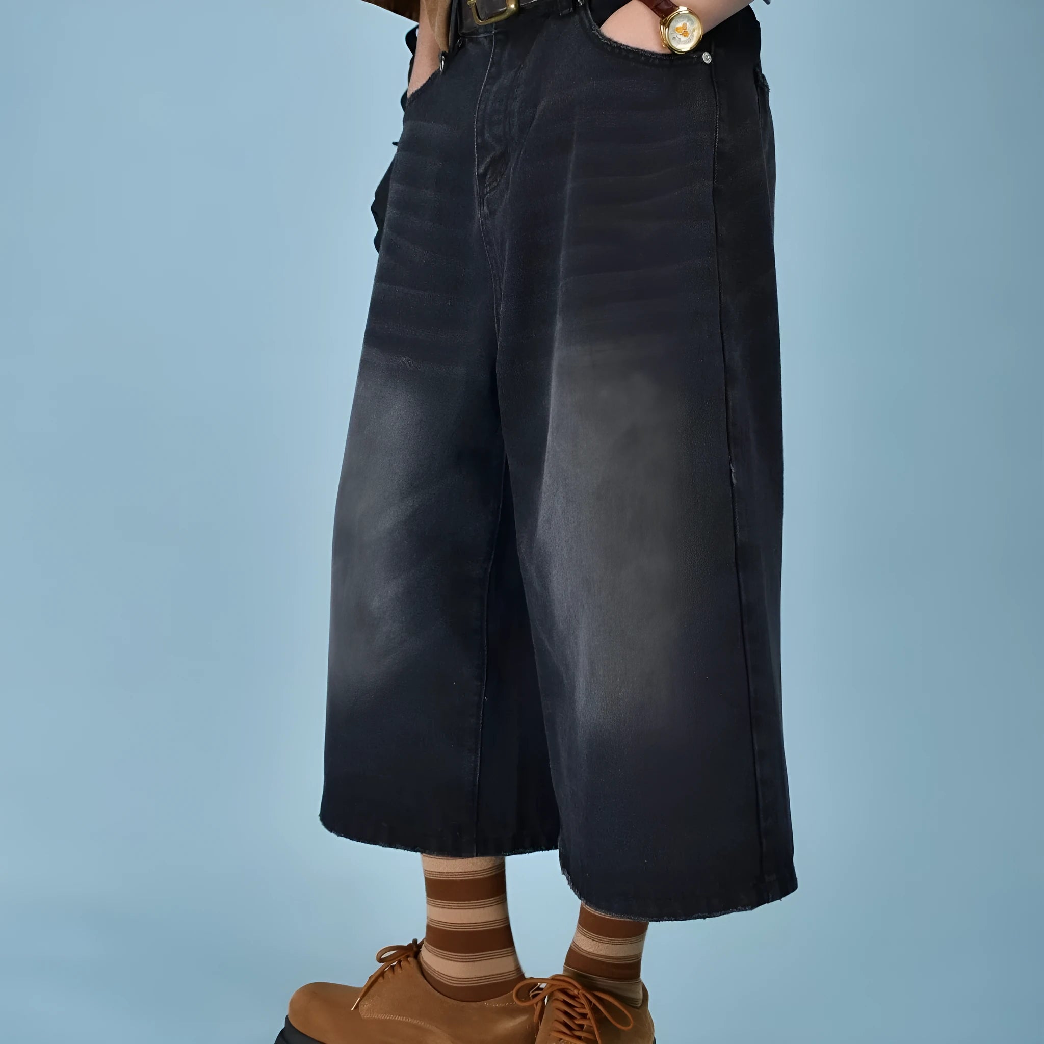 Men's loose fit jeans shorts in blue denim with a straight leg, shown on a model.