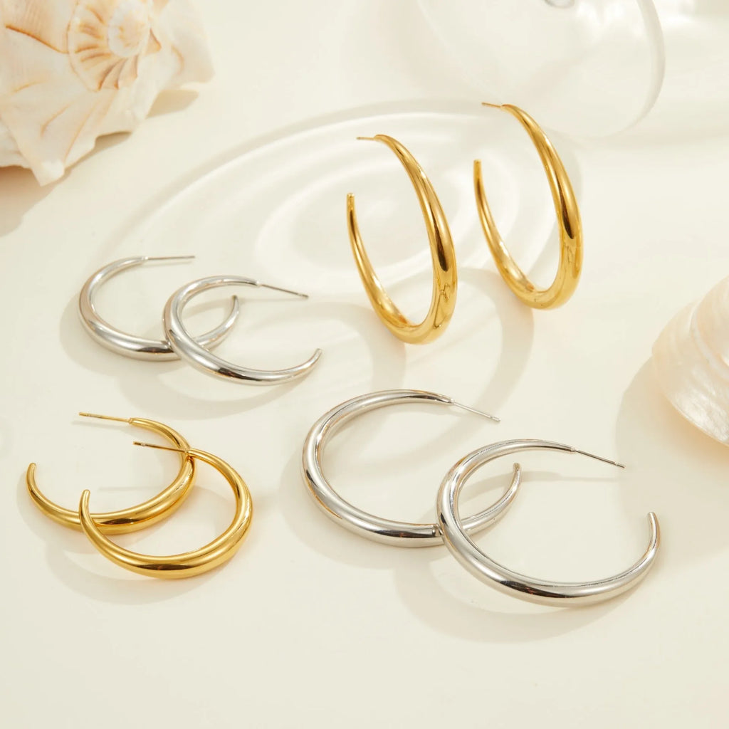 Geometric round stainless steel hoop earrings with gold plating, shown in large and small sizes.