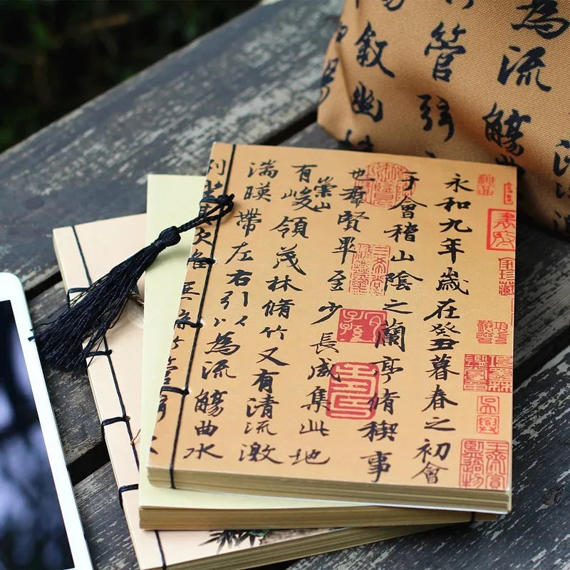 A5 antique wire-bound notebook with retro painting cover, open to show Kraft paper pages