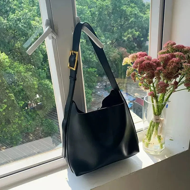 Women's soft PU leather shoulder bag with swing thread detailing in black or brown colour options