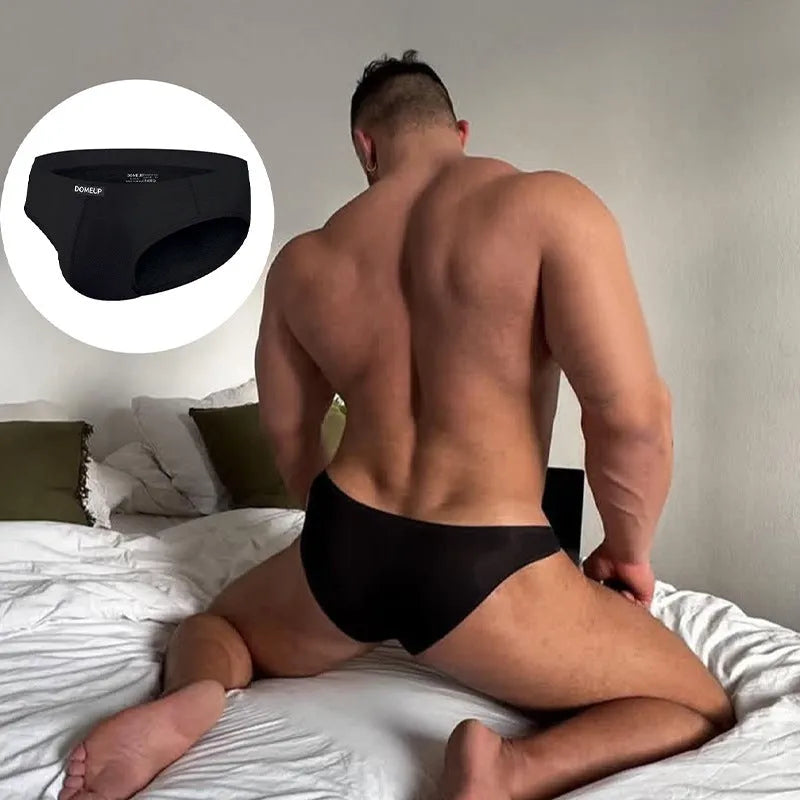 Men's solid colour low-waist briefs in black, shown flat, highlighting seamless construction.
