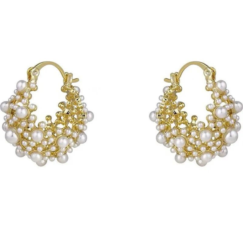 Gold-coloured copper flower basket earrings with small rice-shaped bead inlay detail.