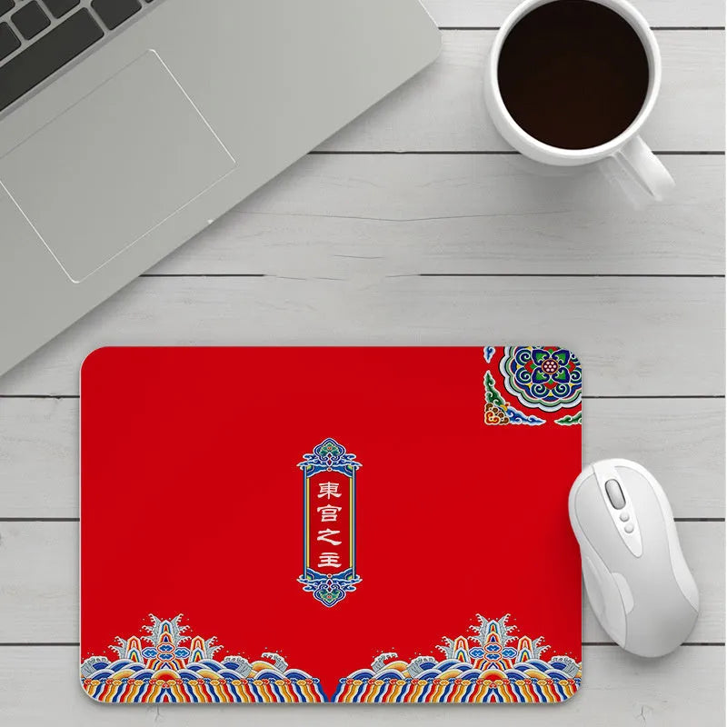 Custom cartoon thickening mouse pad on a desk, showing a colourful design with black stitched edge.