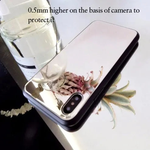 Black mirrored back cover phone case for Apple iPhone models on a table.