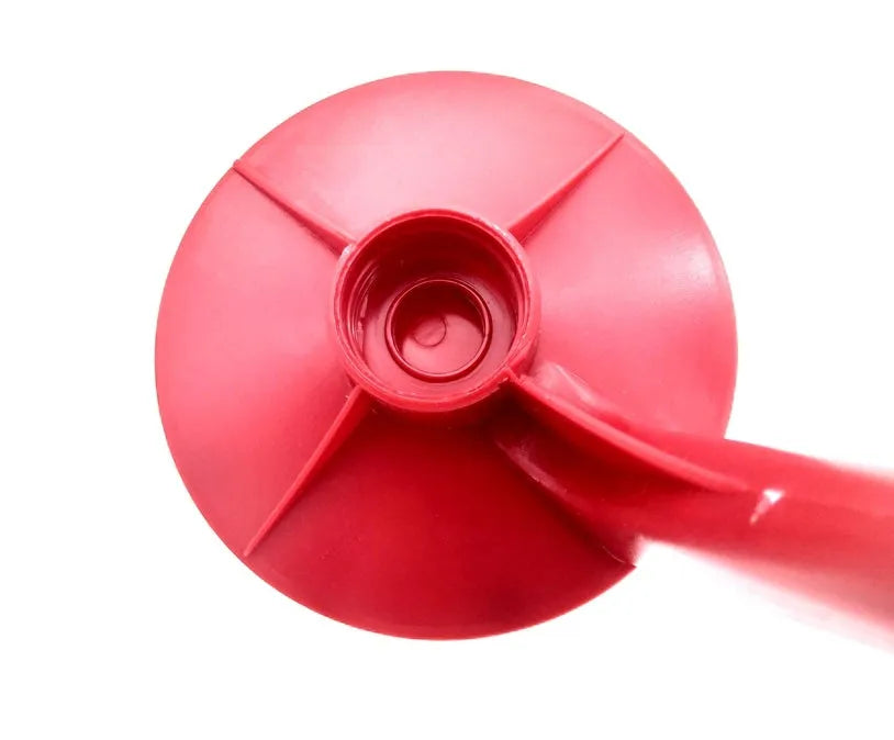 Red plastic Magic Tap soda dispenser attached to an inverted 2-litre bottle for serving fizzy drinks