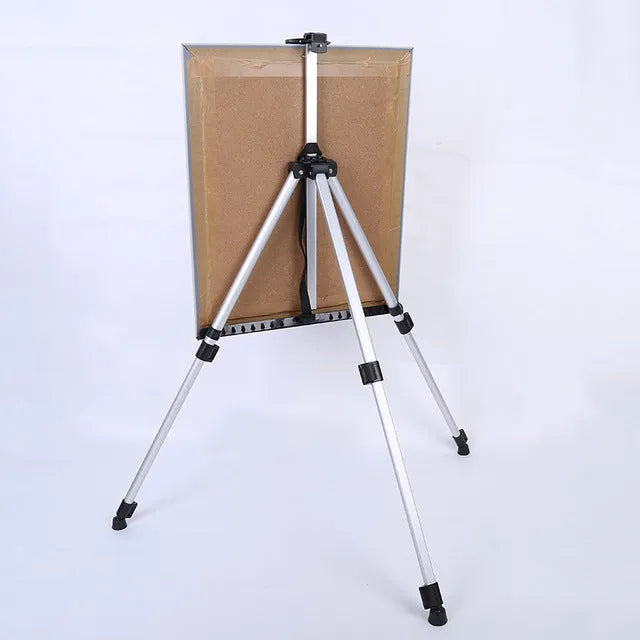 Silver aluminium alloy adjustable painting easel on floor with canvas, folded length 21 inches