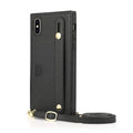Black leather iPhone case with card holder slot and detachable wrist strap on a table