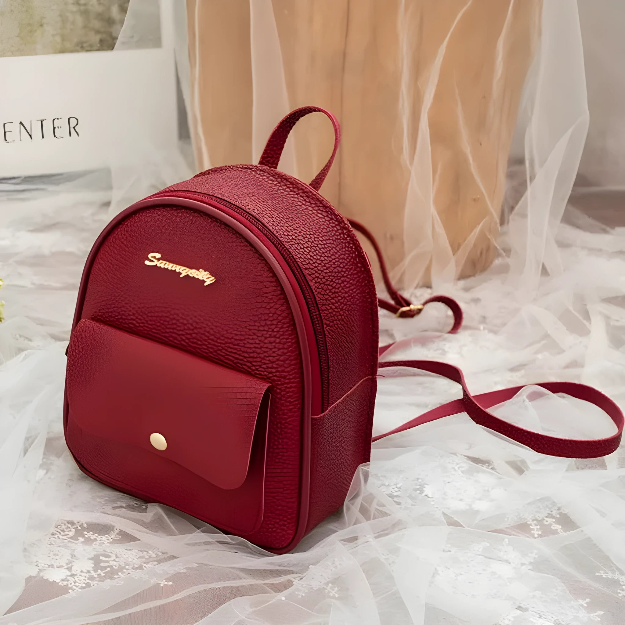 Compact black PU women's shoulder bag also worn as a small backpack, showing zipper closure.