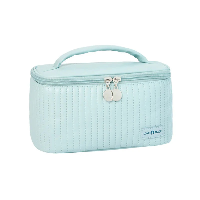 Open-top cake-shaped women's makeup bag in PU leather, shown in a choice of six solid colours.
