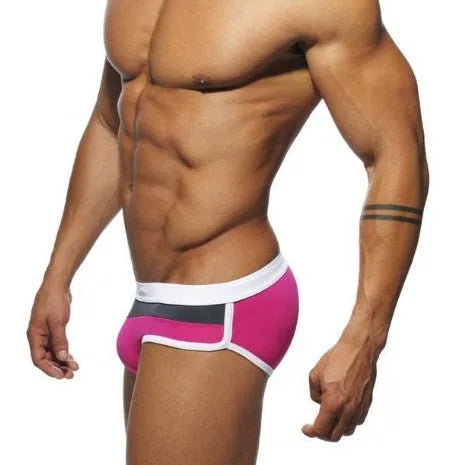 Men's nylon patchwork swim trunks in black, dark blue, and pink, available in sizes M to XXL