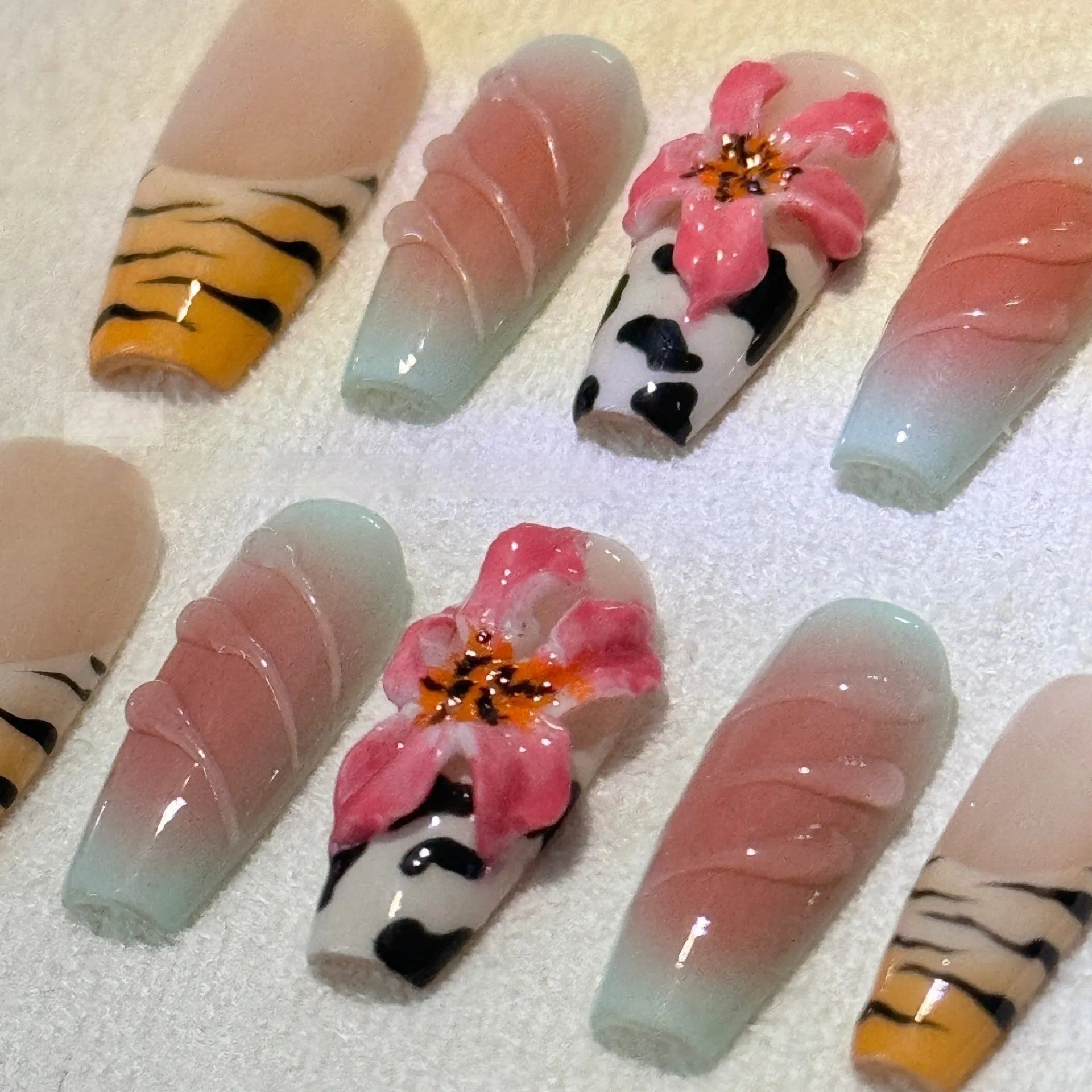 Zebra pattern lily hand carving nail art set showing flower, leopard print, and embossed designs in various sizes.