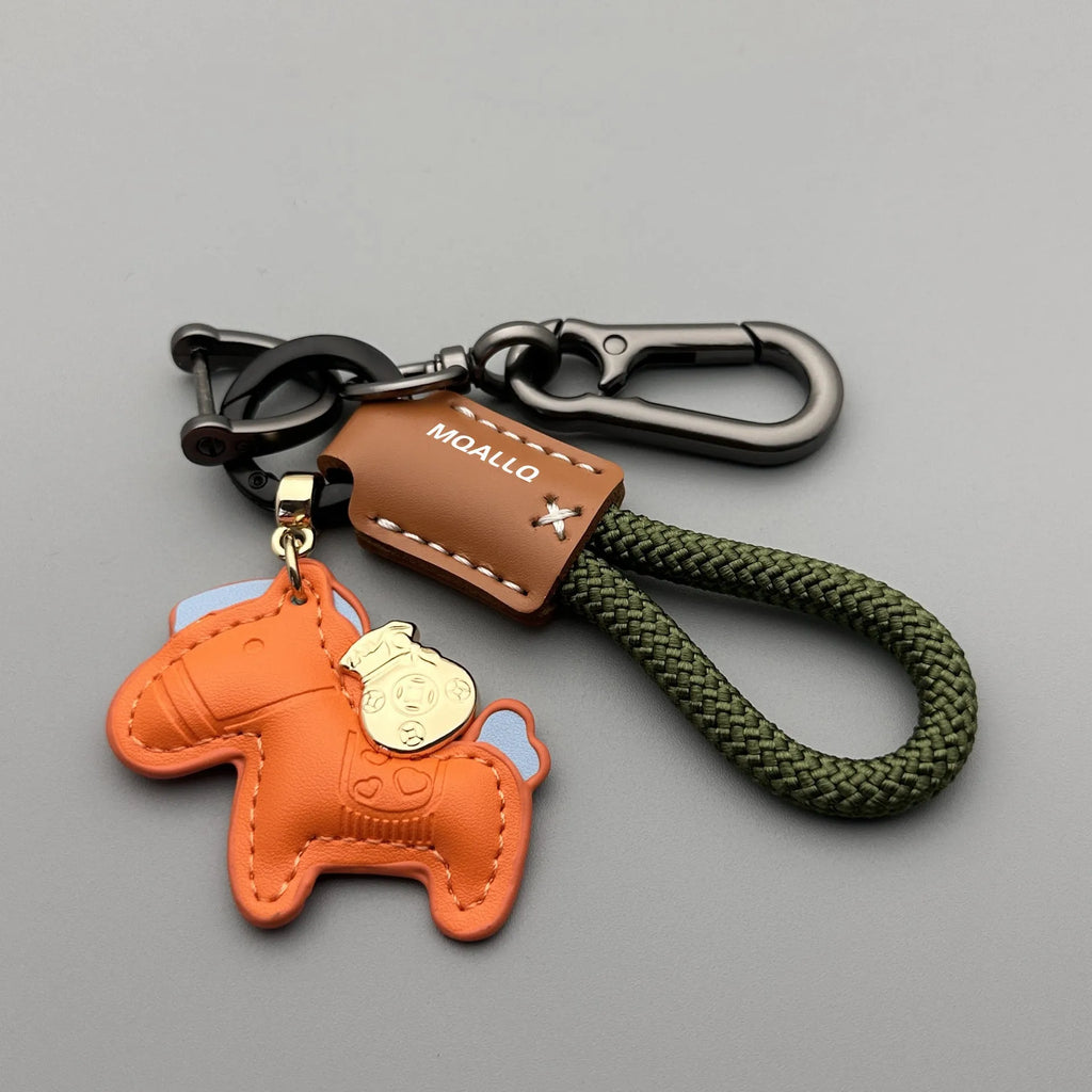 Handmade brown cowhide car key pendant with green flanelle rope and a metal buckle.