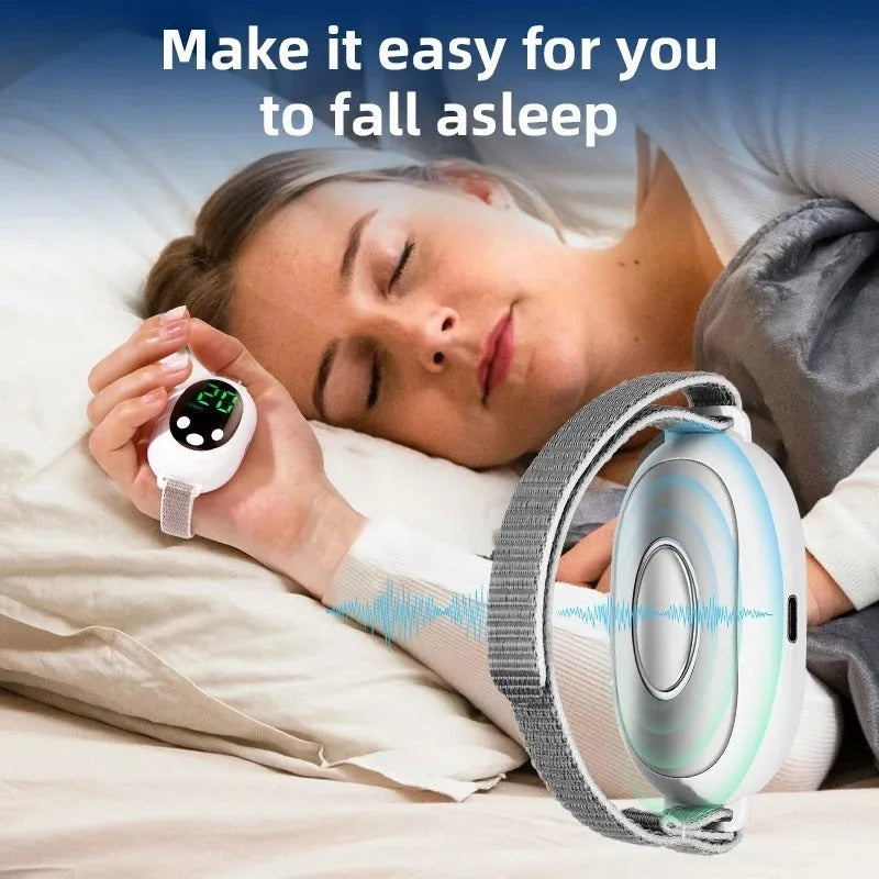 White handheld sleep aid device with remote control and wearable bracelet on charging cable