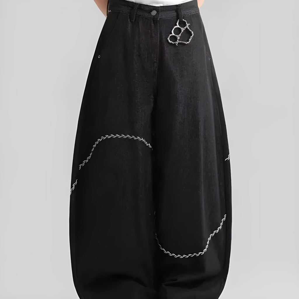 Men's black straight-leg denim trousers with a zip fly on a mid waist, shown in a casual street style.