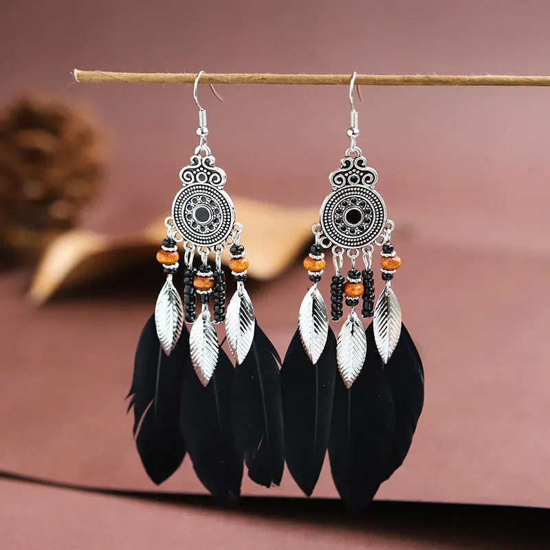 Round drop feather earrings with leaf detailing in various bohemian colours