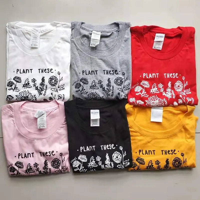 Woman wearing a white cotton Save The Bees t-shirt with a cartoon natural scenery print