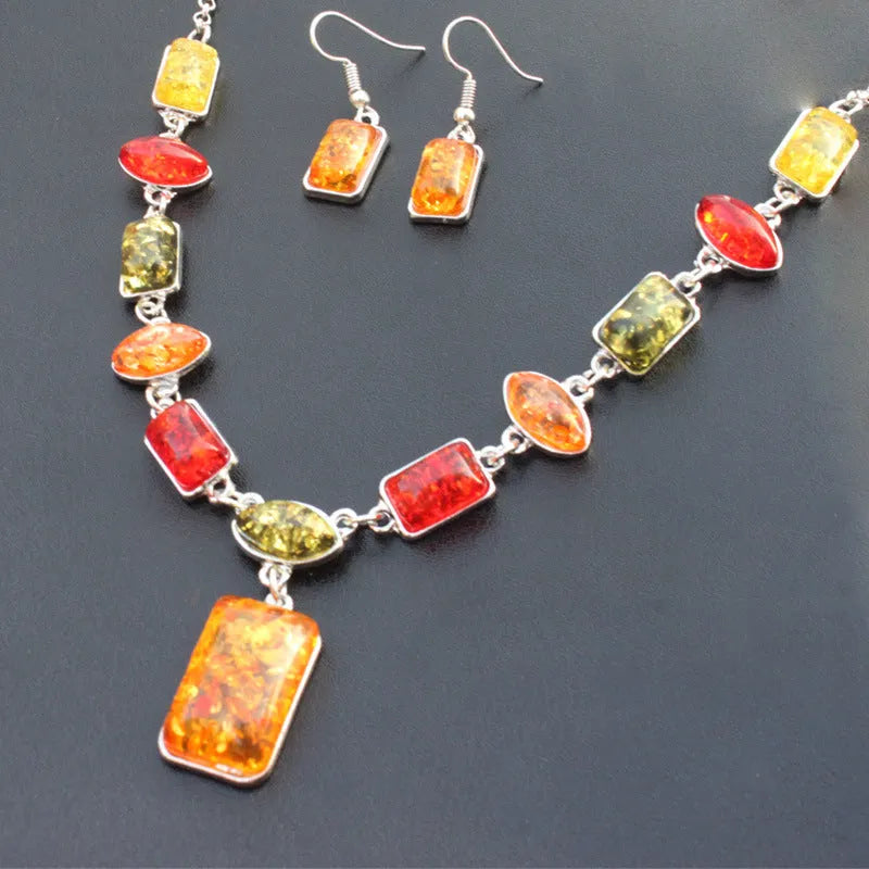 Two-piece jewellery set with alloy electroplated white pendant necklace and earrings featuring artificial gems.