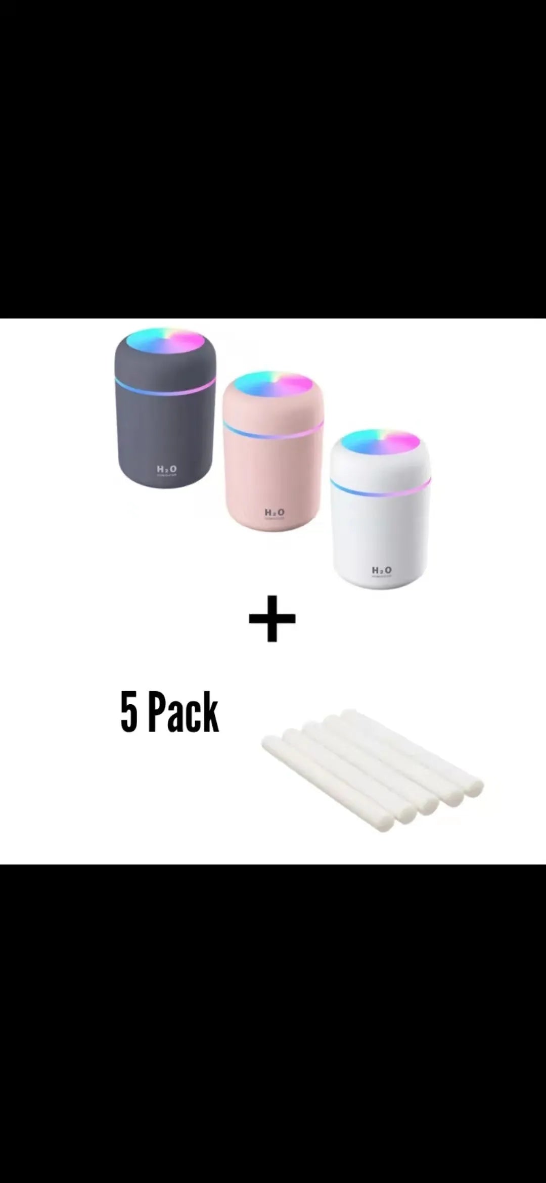 Pink USB mini humidifier with LED lights and water tank on desk