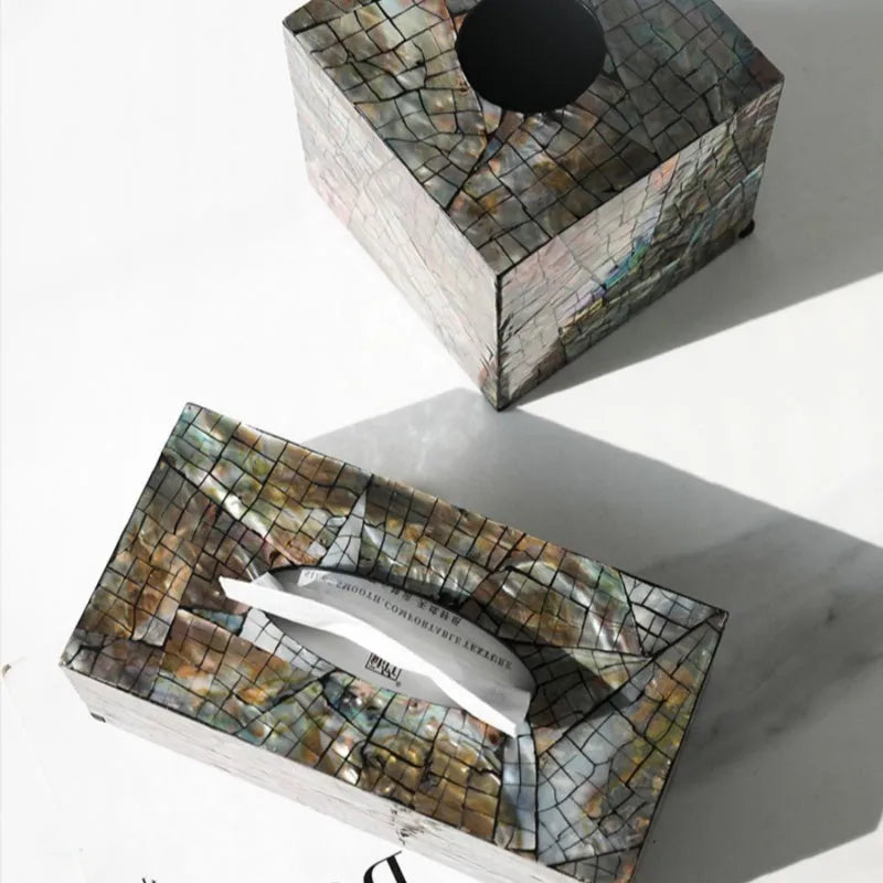 Black rectangular natural shell tissue box storage container with removable insert on a table.