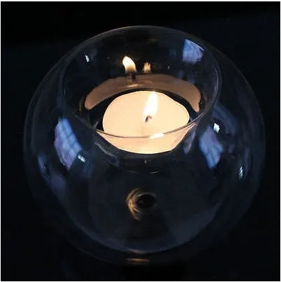 Handmade round transparent glass candle holder showing hollow centre for a candle