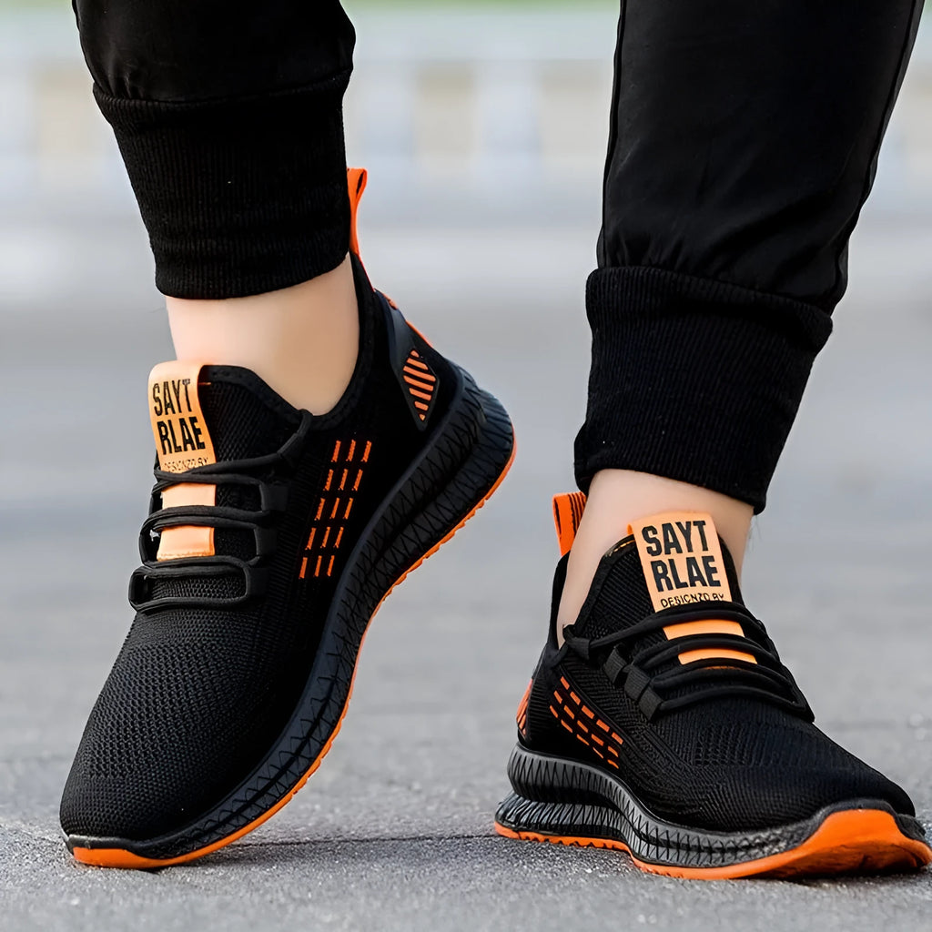 Men's black casual trainers with cross-strap design over striped pattern and Flying Weave fabric upper