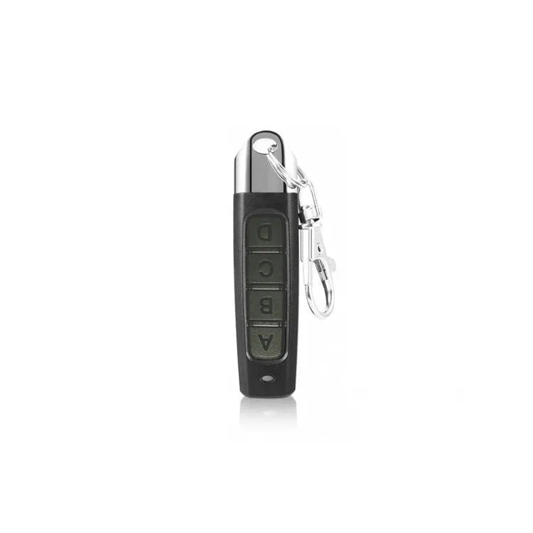 A compact black rolling door remote control measuring 6.7cm, showing buttons for copying and operation.