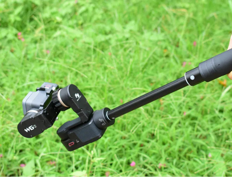 Black retractable selfie stick extended with smartphone mounted in adjustable holder