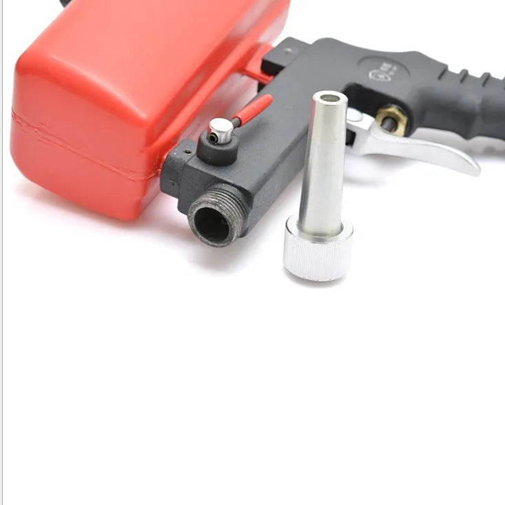 Portable black gravity-feed pneumatic sandblasting gun with a sand tank and trigger.