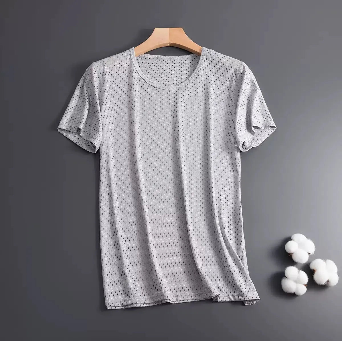 Man wearing a thin grey ice silk mesh short sleeve T-shirt with a crew neck.