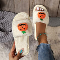 Women's Halloween pumpkin plush slippers in white and yellow with synthetic fur upper