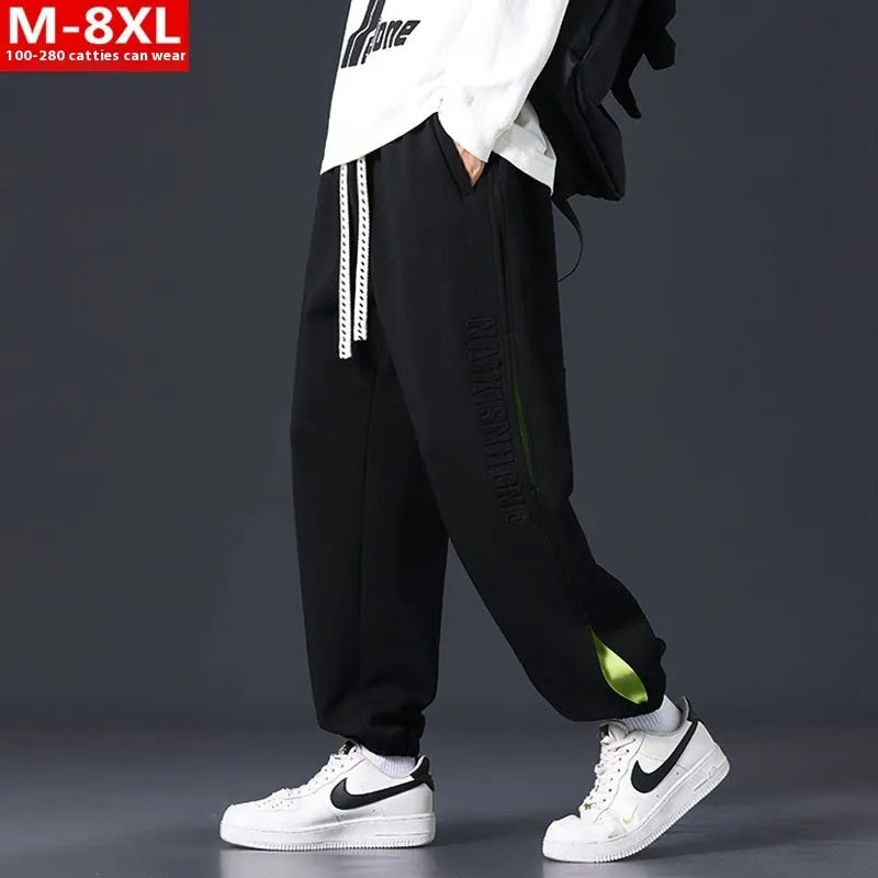 Men's loose fit cotton trousers with banded ankles and stitching details in grey green colour