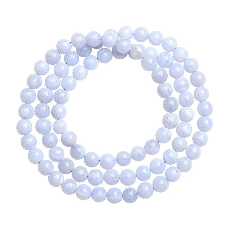 Blue agate bracelet with natural striped pattern and scattered bead design featuring Ruyi elements