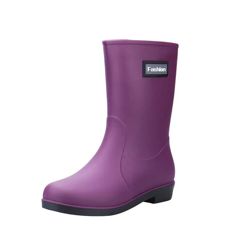 Women's mid-calf PVC rain boot in black, shown with a low heel and optional wool lining.