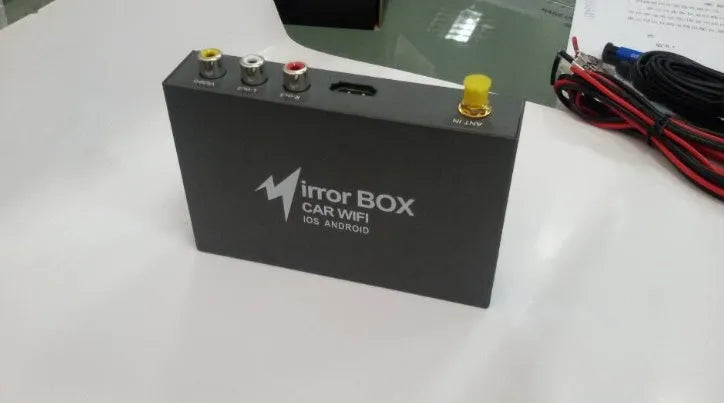 Black car mirror link box converter unit with power cable, AV cable, antenna, and user manual for smartphone screen mirroring.