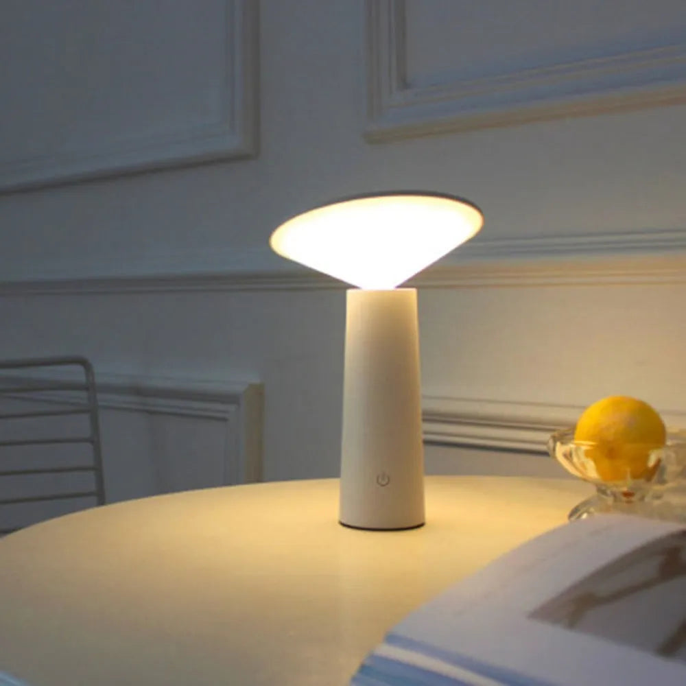 Black or white USB LED desk lamp with touch sensor and adjustable lamp head on a desk