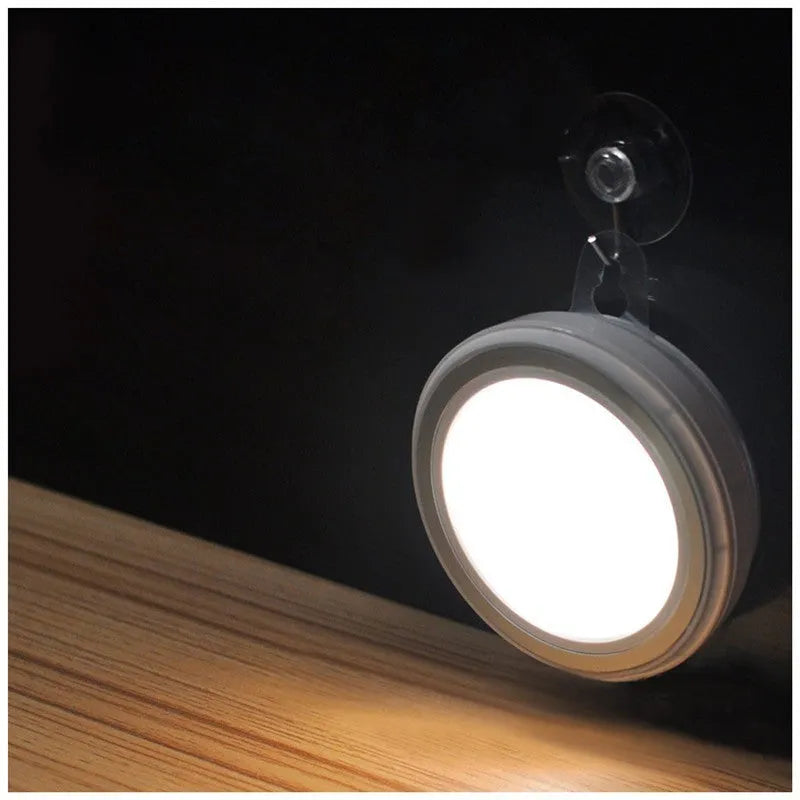 Round white motion sensor LED light unit with 80mm diameter, for cupboard or wall mounting.
