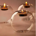 Handmade round transparent glass candle holder showing hollow centre for a candle