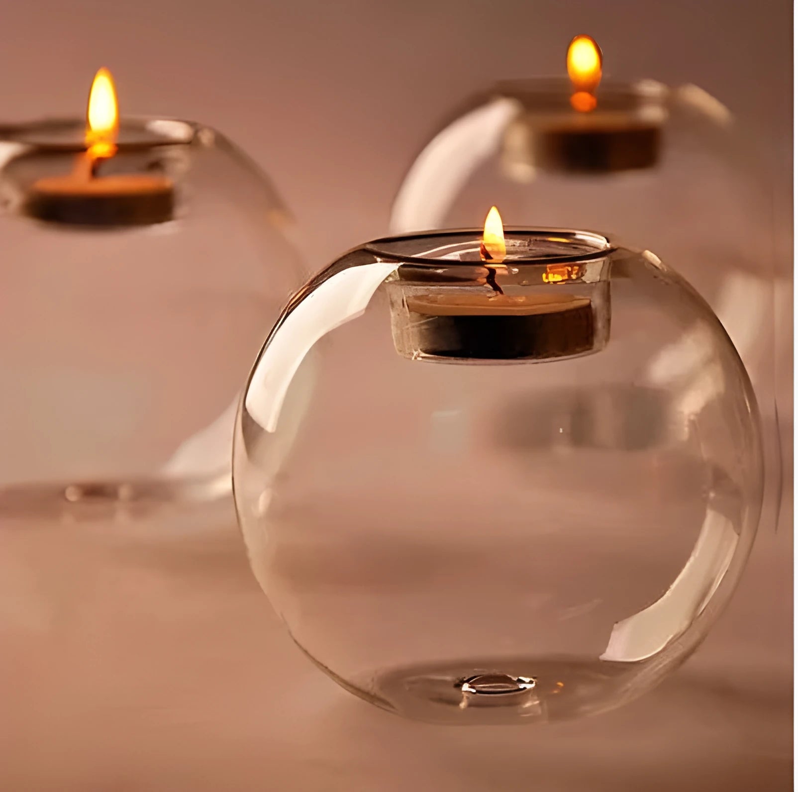 Handmade round transparent glass candle holder showing hollow centre for a candle
