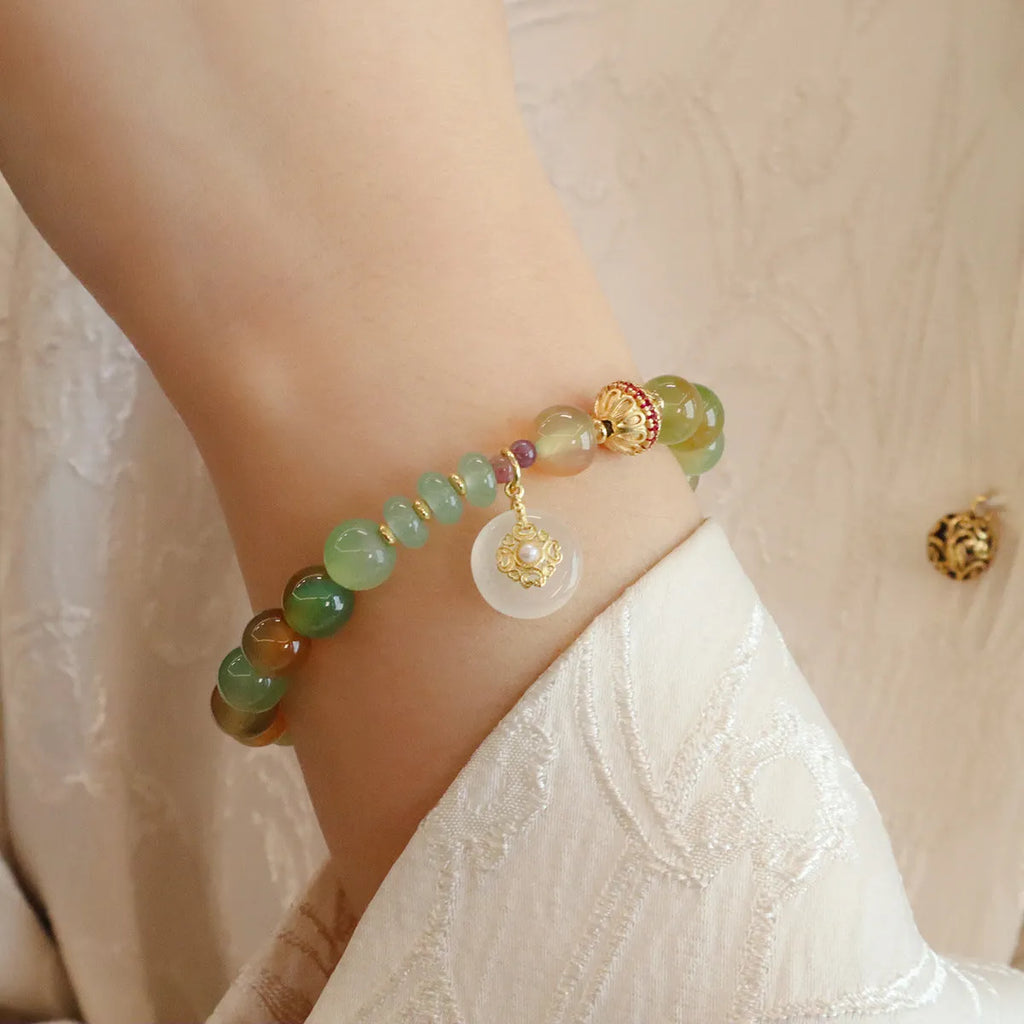 Natural peacock green agate bracelet with 8mm beads and butterfly peace buckle on white background