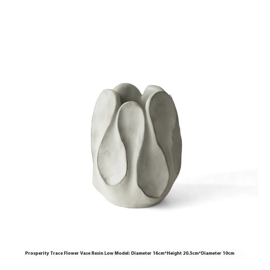 Handmade irregular shaped ceramic vase in natural glaze on a wooden surface.