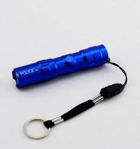 Black aluminium alloy mini LED flashlight showing compact size next to a AA battery for scale.