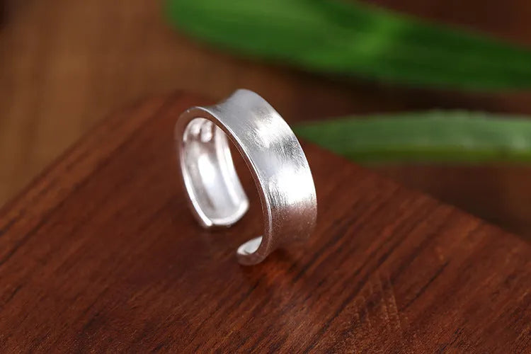 Geometric adjustable open ring with frosted sterling silver finish and Korean-inspired design