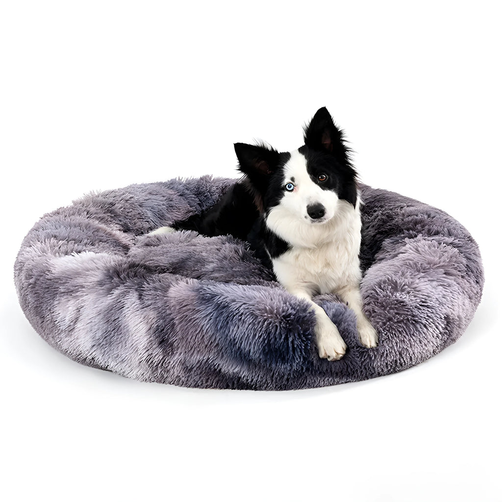 Fluffy donut-shaped pet bed in long plush fabric, shown in a light grey colour.