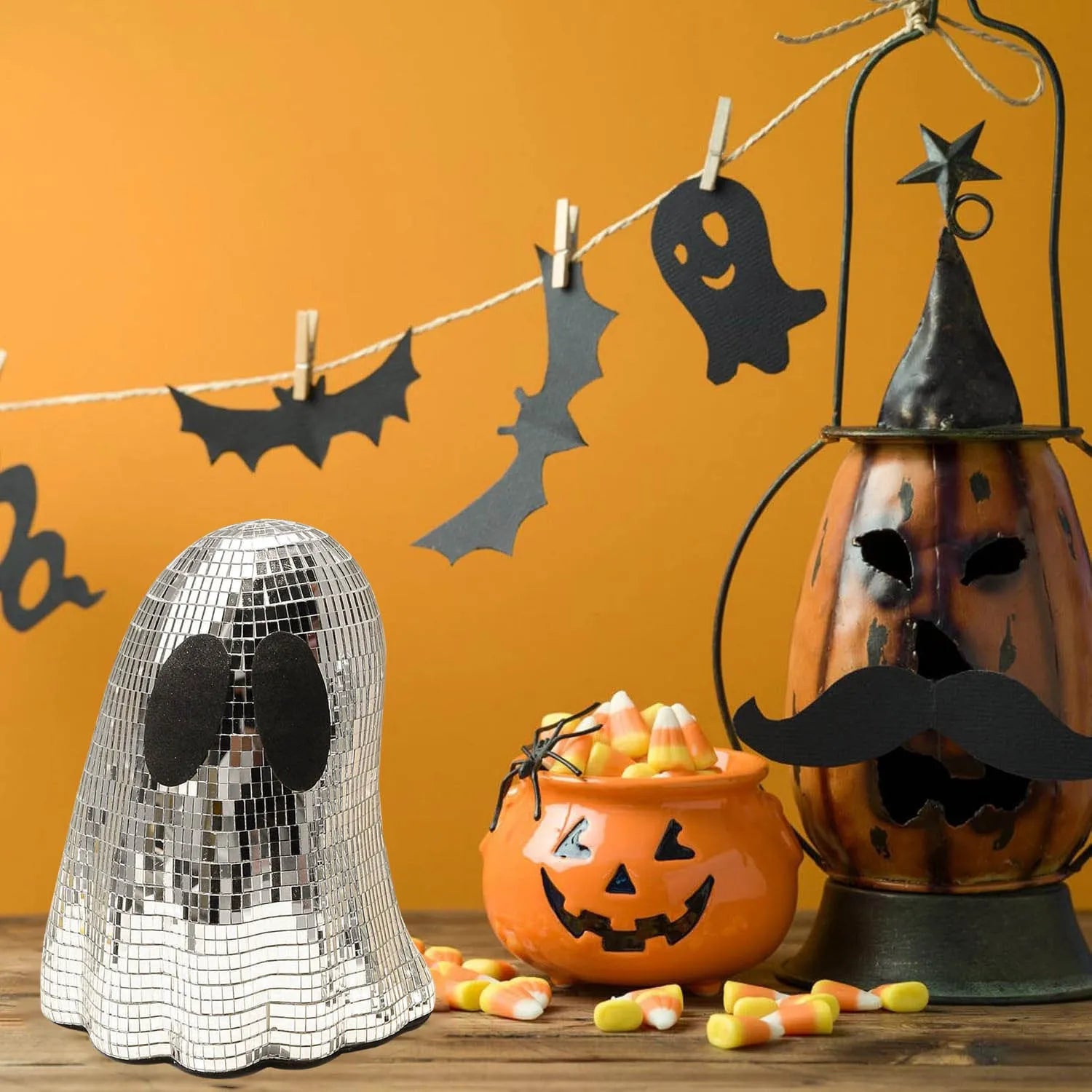 Silver Halloween ghost ornament with mosaic glass surface on wooden desk