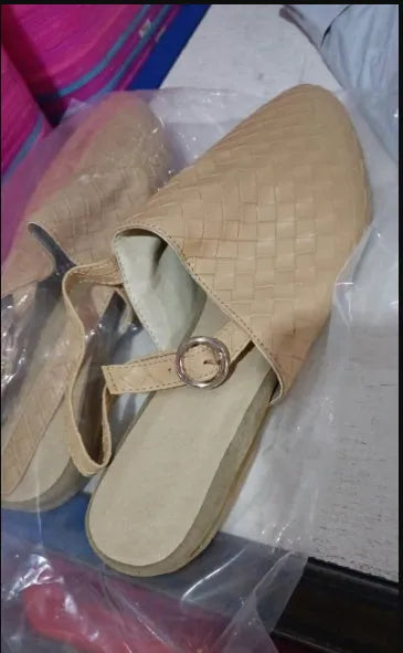 A pair of flat buckle sandals with a pointed toe, shown in one of the available colours.