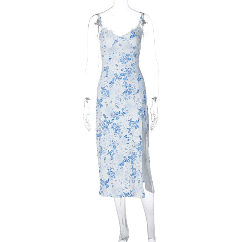 Women's blue long dress with white lace flower print, side slit, and thin adjustable suspender straps.