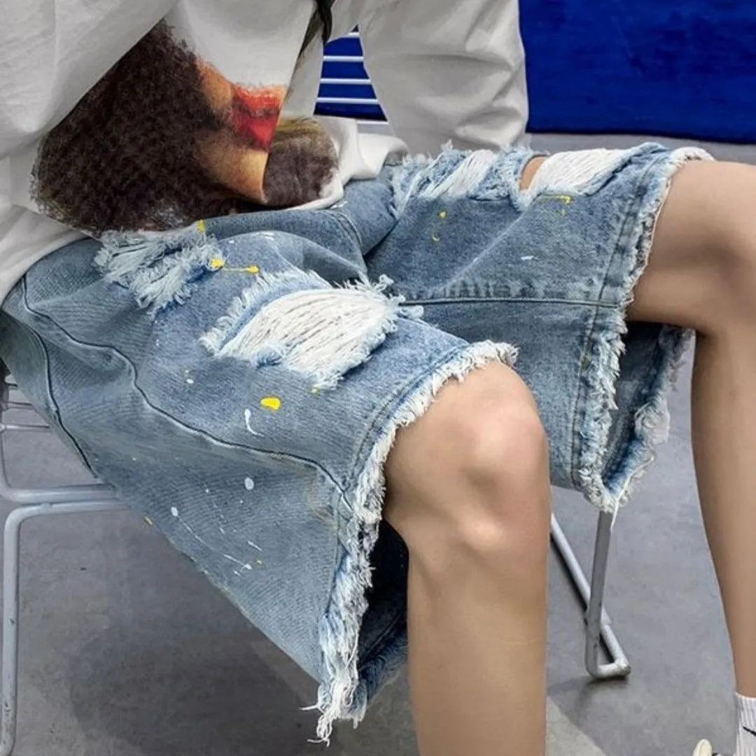 Men's water washed hole denim shorts in loose fit street style, available in black and light blue