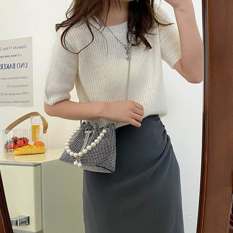 Women's soft PU light diamond decorated crossbody shoulder bag with chain strap in bucket shape.